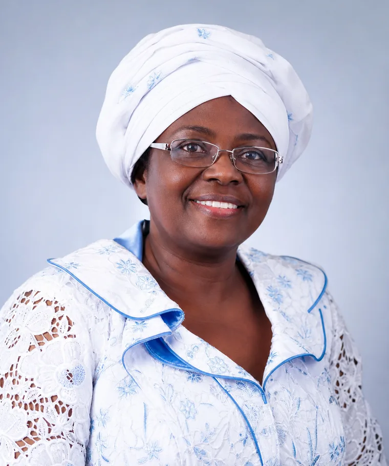 Portrait of a church leader wearing a white hat and jacket