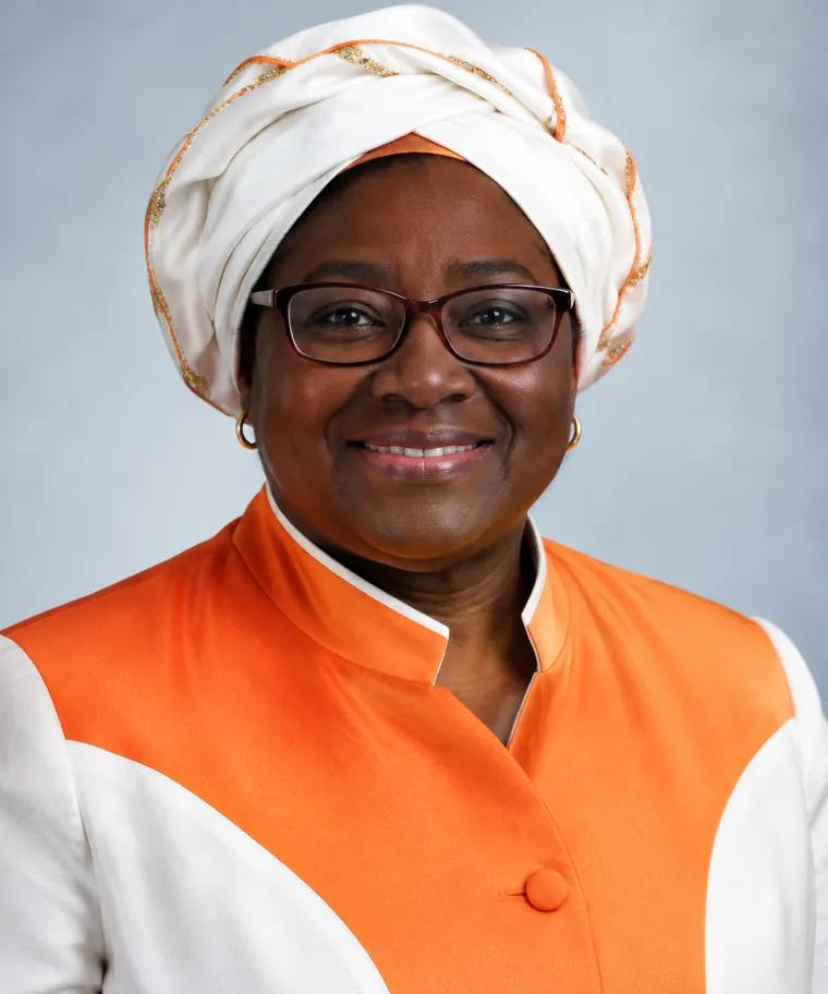Portrait of a church leader wearing an orange jacket and head wrap