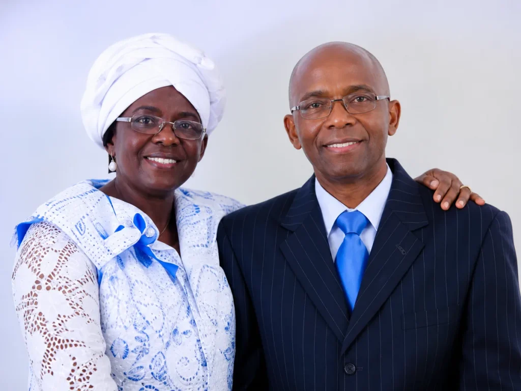 Two church leaders in formal attire standing together and smiling
