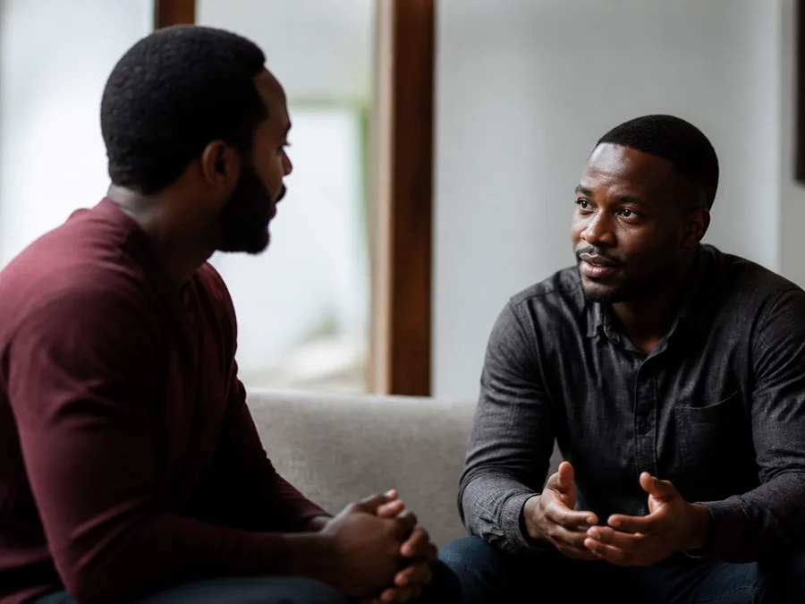 Men seated together in a small-group Bible study discussion